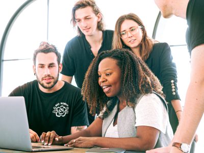 Credit: Canva Studios; Woman sharing presentation with colleagues