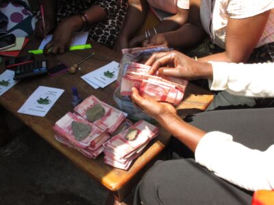 Pooled money is collected and counted. Photo credit: Hugh Allen