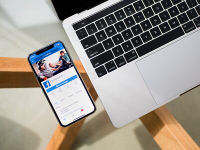 computer keyboard with a mobile phone with Facebook loaded